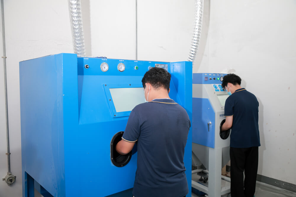 Operators working at enclosed blasting cabinets