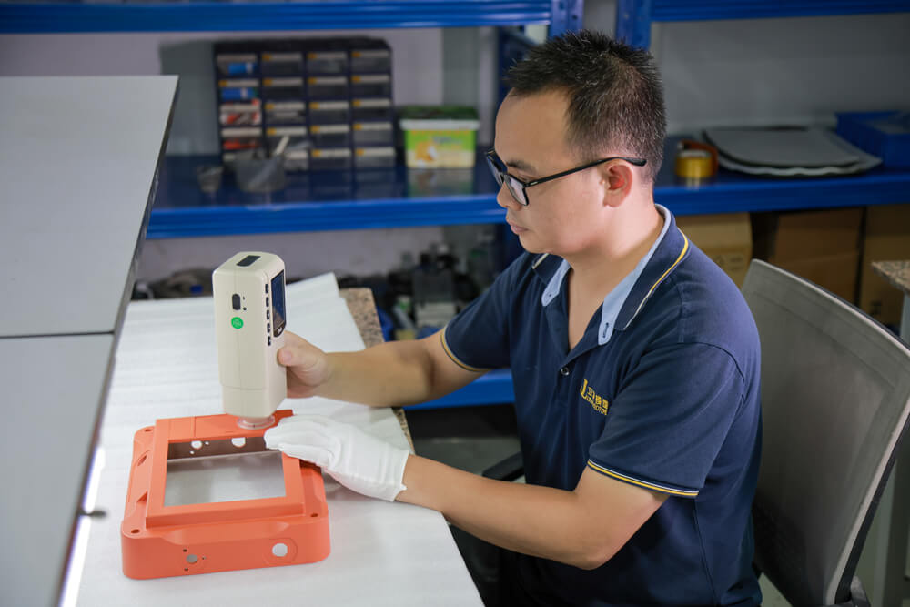 Technician using a handheld instrument on a finished housing