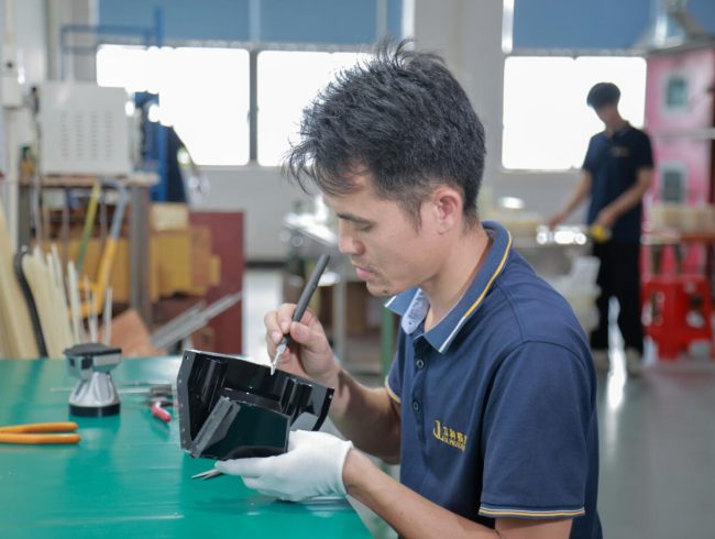 Inspector checking a finished component by hand for appearance and workmanship